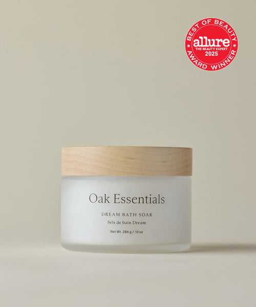 A jar of Dream Bath Soak with a wooden lid is centered on a beige background, highlighting the soothing magnesium soak. The Allure Best of Beauty Award Winner 2023 red badge appears in the top right corner.