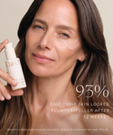 A woman with long brown hair applies Firming Plant Peptide Serum to her cheek while holding an Oak Essentials bottle. Text on the image reads, 93% said their skin looked plumper/fuller after 12 weeks.