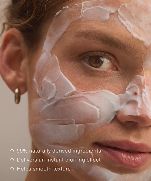 Close-up of a womans face with Refining Mask applied, skin appears smooth. Text: 99% naturally derived ingredients; delivers an instant blurring effect; infused with ceramides to help smooth texture.