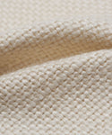 Close-up of the Fabric Swatch Pearl Linen featuring a cream-colored, chunky weave that highlights its detailed fibers and soft, textured surface.