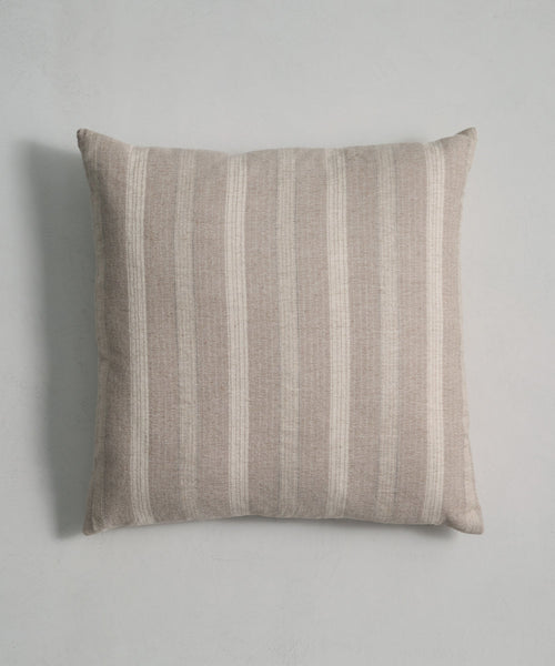 Handwoven from linen, the Laurel Pillow features light beige and off-white vertical stripes. Its soft, textured fabric adds a minimalist touch, making it a versatile, neutral accent for any space.