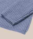 Close-up of the sleeve and hem of the Kids’ Cashmere Fisherman in light blue, highlighting the soft Mongolian cashmere’s texture and fine stitching against a neutral background.