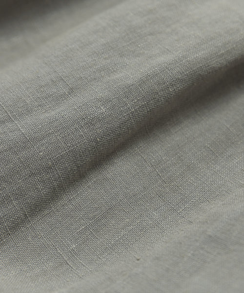 Close-up of the Linen Logan Shorts light gray linen fabric, showcasing its textured weave, gentle folds, and soft, natural surface—slightly wrinkled for relaxed, warm-weather style.