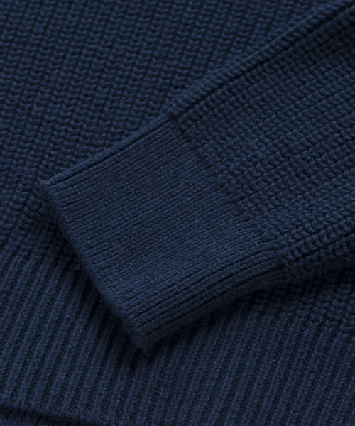 Close-up of the Oversized Cotton Fisherman sweater in navy, featuring a textured waffle pattern and ribbed sleeve cuff—a must-have women’s knit with a relaxed, fisherman-inspired style.