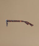 Tortoise sunglasses against a beige background.