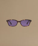 Tortoise sunglasses against a beige background.
