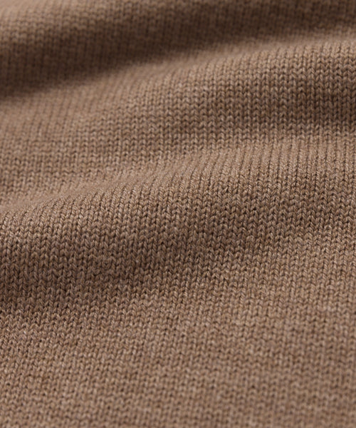 Close-up of the Simone V-Necks brown knitted cotton merino fabric, featuring a visible ribbed texture and gentle folds—showcasing its soft, cozy feel thats perfect for a luxurious layer.