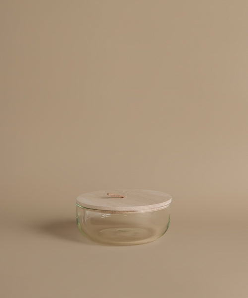 Glass canisters against a beige background.