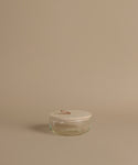 Glass canisters against a beige background.