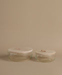 Glass canisters against a beige background.
