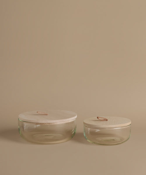 Glass canisters against a beige background.