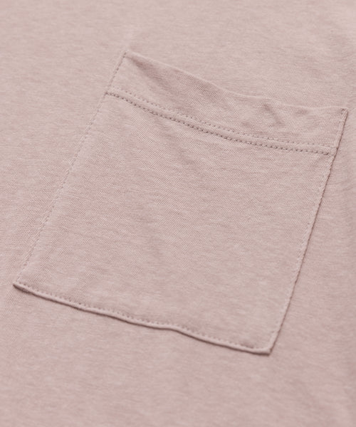 Close-up of the Vintage Pocket Tee in light pink, highlighting the sewn-on patch pocket with visible stitching and textured fabric—an essential detail for any everyday wardrobe.