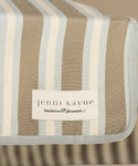 Detailed image of a stripe beach umbrella against a beige background