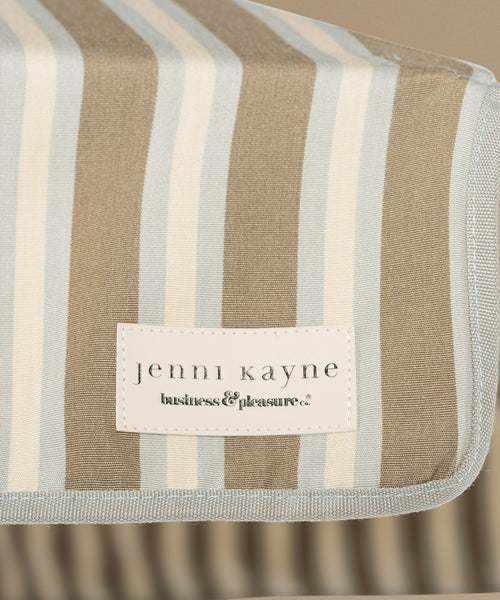 Detailed image of a stripe beach umbrella against a beige background