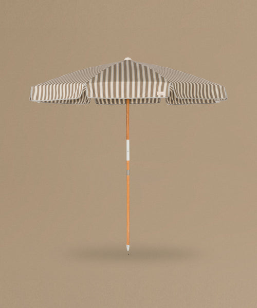 Stripe Beach Umbrella against a beige background