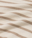Close-up of the Avery Crewneck, a lightweight knit with beige and white horizontal stripes. The soft cotton-merino fabric features gentle folds and a smooth, flexible texture.