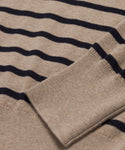 Close-up of the Avery Crewneck in beige with black horizontal stripes, showcasing the ribbed cuff and part of the sleeve laid flat.