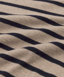 Close-up of the Avery Crewneck’s beige fabric with horizontal black stripes, highlighting its textured surface and soft folds—a great choice for an effortless coastal style.