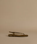 Olive sandal on a beige background