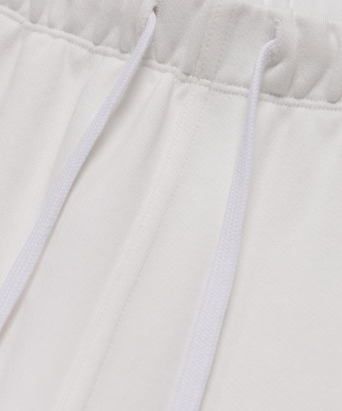 Close-up of the waistband on the Bay Sweatpant, showcasing its elastic band and two white drawstrings over soft brushed fleece fabric.