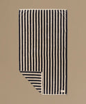 Striped fabric with black and white stripes on a beige background