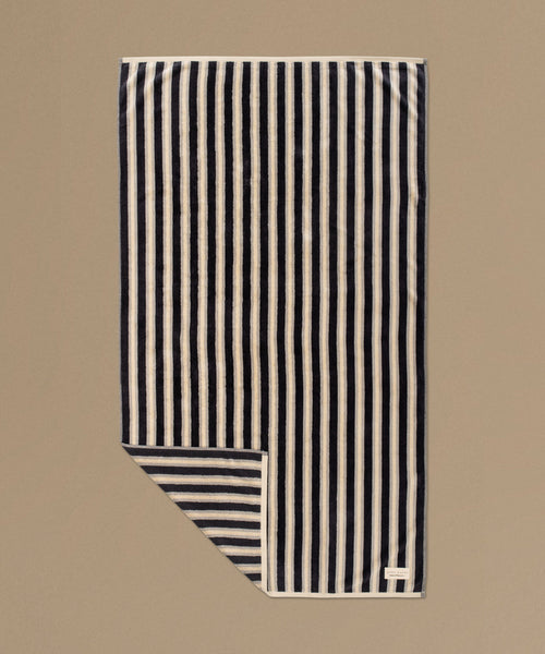 Striped fabric with black and white stripes on a beige background