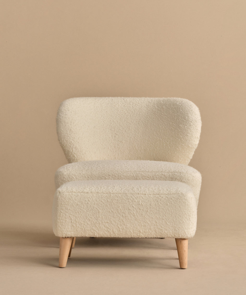 The Brentwood Chair paired with its matching foot stool creates a cozy and stylish seating option.
