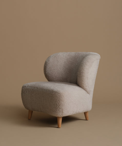 Beige armchair on a brown background