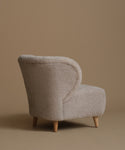 Beige armchair on a brown background