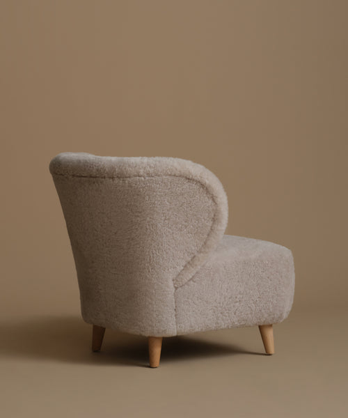 Beige armchair on a brown background