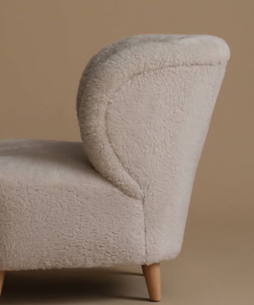 Beige textured armchair on a brown background