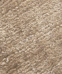 Close-up of the Rug Swatch in beige, featuring a soft, textured, and slightly mottled surface. The mocha-toned fibers look plush and dense, giving the swatch a cozy, warm appearance.