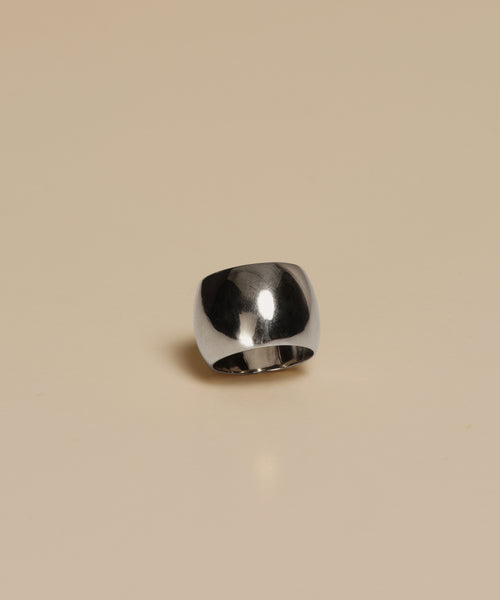 The Campbell Cigar Band, a wide polished ring with a smooth curved surface, is displayed on a plain beige background.