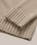 Close-up of the ribbed cuffs and hem on the beige Cashmere Amelia Crewneck, highlighting its texture and stitching details against a neutral background.