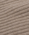 Close-up of the Cashmere Beanie's beige ribbed knit fabric, highlighting its soft wool fibers—ideal for a lightweight beanie with a relaxed fit.