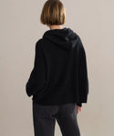 Back studio shot of boxy cashmere hoodie with fisherman stitch.