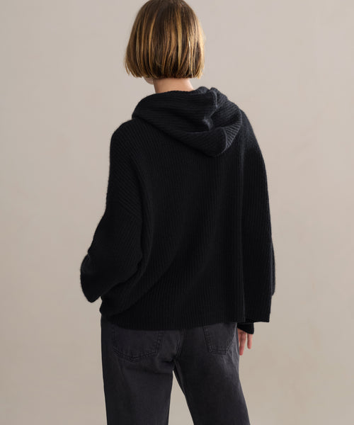 Back studio shot of boxy cashmere hoodie with fisherman stitch.