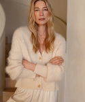 Lifestyle shot of cashmere brushed v-neck cardigan with puff sleeve. 