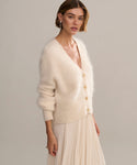 In-studio side shot of cashmere brushed v-neck cardigan with puff sleeve. 