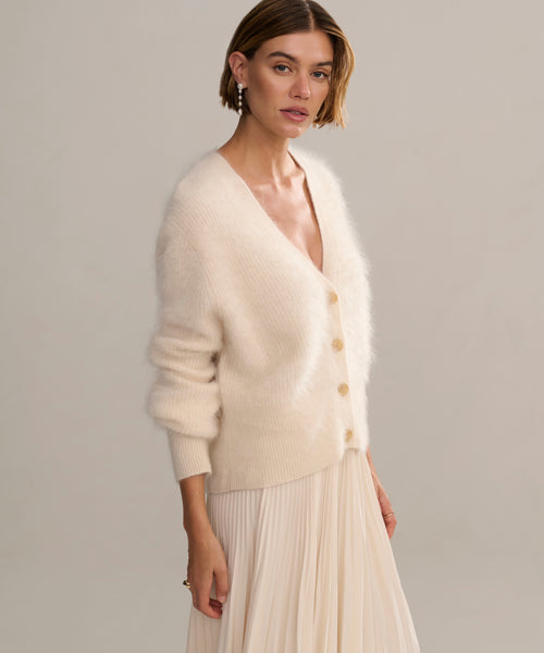 In-studio side shot of cashmere brushed v-neck cardigan with puff sleeve. 