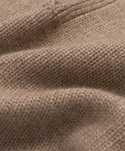 Close-up of the Cashmere Phoebe Polo, a soft, light brown womens sweater made from 100% cashmere, highlighting its textured stitches and gentle folds for a luxurious feel.
