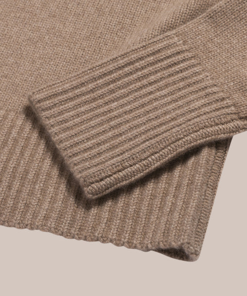 Close-up of the Cashmere Phoebe Polo in light brown, showcasing its ribbed cuff and hem. Made from 100% cashmere and set against a neutral background.