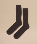 Cashmere Socks in black with a ribbed crew design are laid flat on a light beige background—perfect as a fall or winter gift.