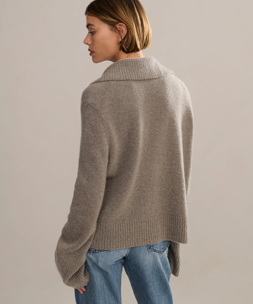 Back of sweater featuring ribbed collar and ribbed trim along the sleeves and waist.
