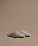 Pair of beige mules on a beige background