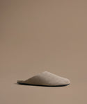 Beige mule on a brown background