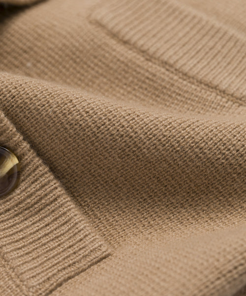 Close-up of the Charlotte Cardigan’s textured light brown knit fabric, showcasing its detailed woven pattern, button, and pocket seam—an elegant detail for women’s fashion.