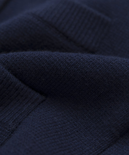 Close-up of the Charlotte Cardigan’s dark navy blue knit, showcasing its soft texture, ribbed pattern, and gentle folds—a must-have women’s cardigan for any wardrobe.