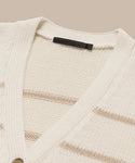 Close-up of the cream-colored Chloe Cardigan with subtle beige stripes, a v-neckline, and a black Jenni Kayne label on the collar—ideal for your spring and summer wardrobe.