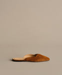 The Clara Mule is an Italian-made shoe in cognac brown suede with a pointed toe and open back, shown on a neutral background.